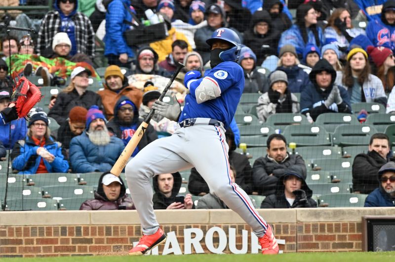 Apr 9, 2025; Chicago, Illinois, USA; Texas Rangers right fielder Adolis Garcia (53) avoids getting hit by a pitch from Chicago Cubs relief pitcher Nate Pearson (56) during the seventh inning at Wrigley Field. Mandatory Credit: Patrick Gorski-Imagn Images