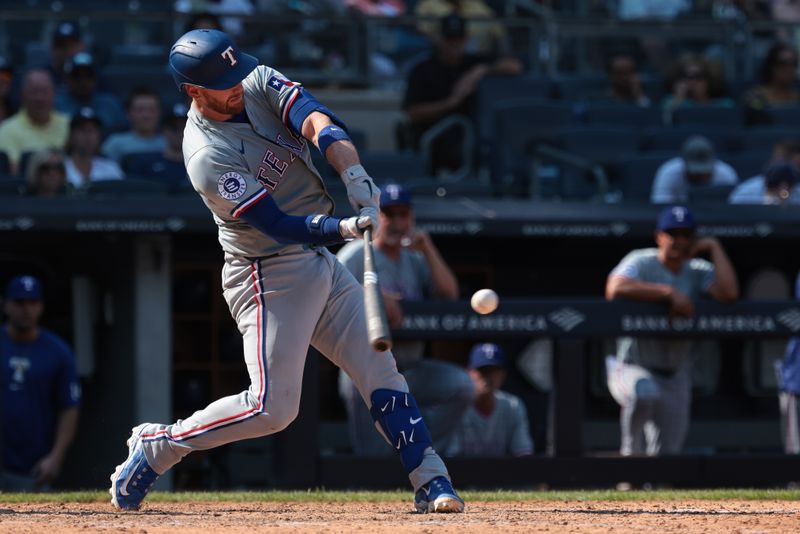 Aug 11, 2024; Bronx, New York, USA; Texas Rangers catcher Carson Kelly (18) hits a two run home run during the eighth inning against the New York Yankees at Yankee Stadium. Mandatory Credit: Vincent Carchietta-USA TODAY Sports