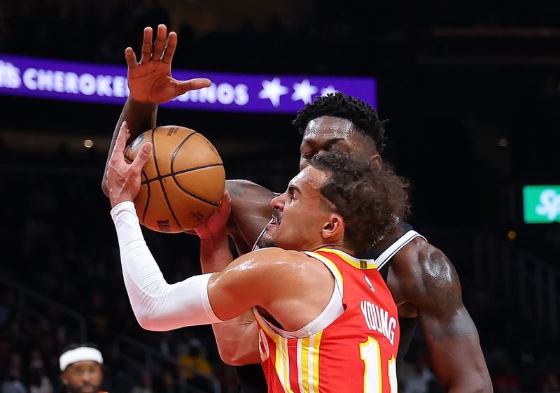 ATLANTA, GEORGIA - DECEMBER 06:  Trae Young #11 of the Atlanta Hawks drives against Dorian Finney-Smith #28 of the Brooklyn Nets during the second quarter at State Farm Arena on December 06, 2023 in Atlanta, Georgia.  NOTE TO USER: User expressly acknowledges and agrees that, by downloading and/or using this photograph, user is consenting to the terms and conditions of the Getty Images License Agreement.  (Photo by Kevin C. Cox/Getty Images)