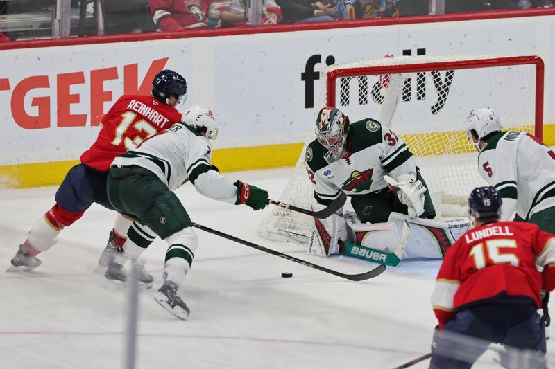 Oct 22, 2024; Sunrise, Florida, USA; Minnesota Wild goaltender Filip Gustavsson (32) makes a save against Florida Panthers center Sam Reinhart (13) during the third period at Amerant Bank Arena. Mandatory Credit: Sam Navarro-Imagn Images