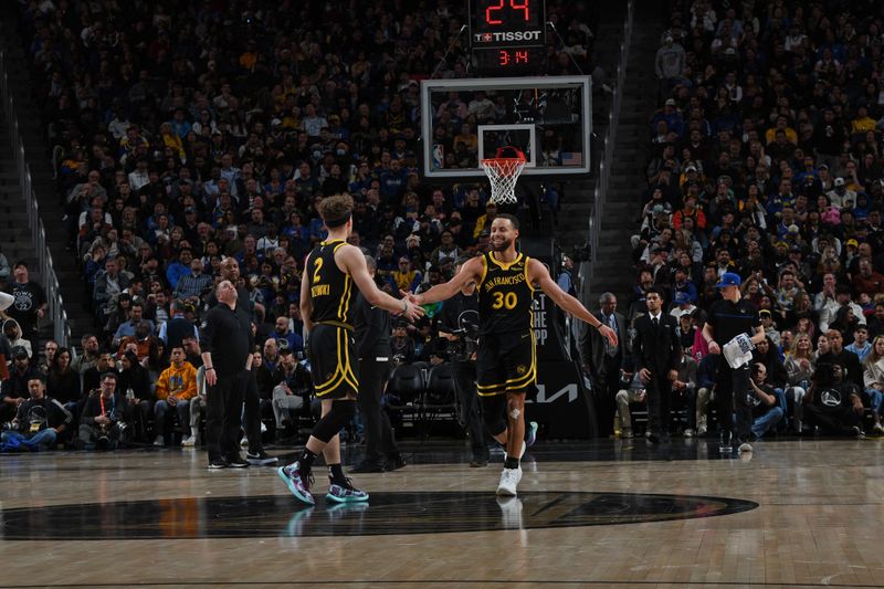 SAN FRANCISCO, CA - FEBRUARY 14: Stephen Curry #30 high fives Brandin Podziemski #2 of the Golden State Warriors during the game against the LA Clippers on FEBRUARY 14, 2024 at Chase Center in San Francisco, California. NOTE TO USER: User expressly acknowledges and agrees that, by downloading and or using this photograph, user is consenting to the terms and conditions of Getty Images License Agreement. Mandatory Copyright Notice: Copyright 2024 NBAE (Photo by Noah Graham/NBAE via Getty Images)