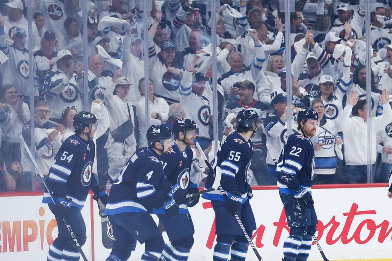Apr 30, 2025; Winnipeg, Manitoba, CAN; Winnipeg Jets forward Kyle Connor (81) is congratulated by his teammates on his goal against the St. Louis Blues during the first period in game five of the first round of the 2025 Stanley Cup Playoffs at Canada Life Centre. Mandatory Credit: Terrence Lee-Imagn Images