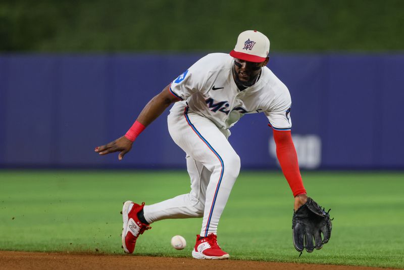 Jul 4, 2024; Miami, Florida, USA; Miami Marlins shortstop Vidal Brujan (17) catches a ground ball to retire Boston Red Sox second baseman David Hamilton (70) during the third inning at loanDepot Park. Mandatory Credit: Sam Navarro-USA TODAY Sports