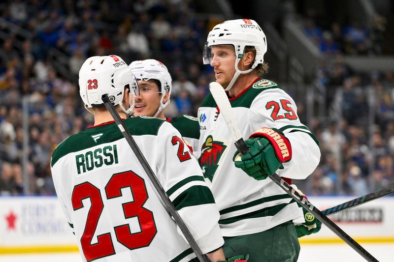 Nov 19, 2024; St. Louis, Missouri, USA;  Minnesota Wild defenseman Jonas Brodin (25) is congratulated by defenseman Jared Spurgeon (46) and center Marco Rossi (23) after scoring against the St. Louis Blues during the third period at Enterprise Center. Mandatory Credit: Jeff Curry-Imagn Images