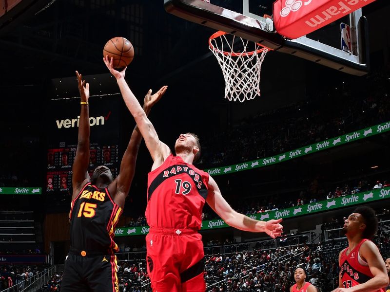 ATLANTA, GA - February 23: Jakob Poeltl #19 of the Toronto Raptors grabs a rebound during the game against the Atlanta Hawks on February 23, 2024 at State Farm Arena in Atlanta, Georgia.  NOTE TO USER: User expressly acknowledges and agrees that, by downloading and/or using this Photograph, user is consenting to the terms and conditions of the Getty Images License Agreement. Mandatory Copyright Notice: Copyright 2024 NBAE (Photo by Scott Cunningham/NBAE via Getty Images)