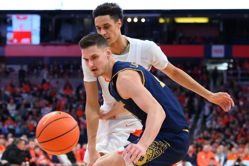 Jan 14, 2023; Syracuse, New York, USA; Notre Dame Fighting Irish forward Nate Laszewski (14) and Syracuse Orange center Jesse Edwards (14) reacts to a loose ball during the first half at the JMA Wireless Dome. Mandatory Credit: Rich Barnes-USA TODAY Sports