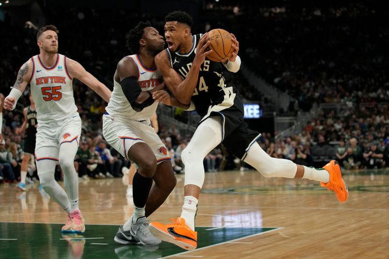 MILWAUKEE, WISCONSIN - APRIL 07: Giannis Antetokounmpo #34 of the Milwaukee Bucks goes to the basket against OG Anunoby #8 of the New York Knicks during the first half at Fiserv Forum on April 07, 2024 in Milwaukee, Wisconsin. NOTE TO USER: User expressly acknowledges and agrees that, by downloading and or using this photograph, User is consenting to the terms and conditions of the Getty Images License Agreement. (Photo by Patrick McDermott/Getty Images)