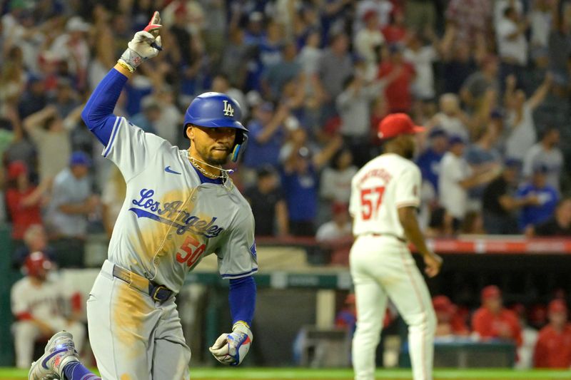 Sep 3, 2024; Anaheim, California, USA;  Los Angeles Dodgers shortstop Mookie Betts (50) celebrates as he rounds the bases after hitting a three-run home run in the tenth inning off Los Angeles Angels relief pitcher Roansy Contreras (57) at Angel Stadium. Mandatory Credit: Jayne Kamin-Oncea-Imagn Images