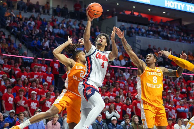 Mar 5, 2025; Oxford, Mississippi, USA; Mississippi Rebels forward Jaemyn Brakefield (4) shoots the ball against Tennessee Volunteers guard Darlinstone Dunbar (8) during the second half at The Sandy and John Black Pavilion at Ole Miss. Mandatory Credit: Wesley Hale-Imagn Images