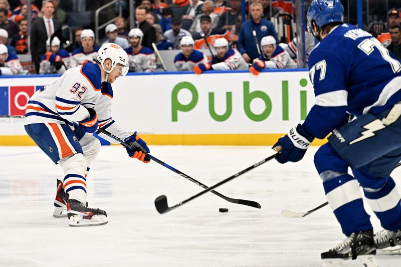 Feb 25, 2025; Tampa, Florida, USA; Edmonton Oilers right wing Vasily Podkolzin (92) takes a shot on goal in the second period against the Tampa Bay Lightning  at Amalie Arena. Mandatory Credit: Jonathan Dyer-Imagn Images