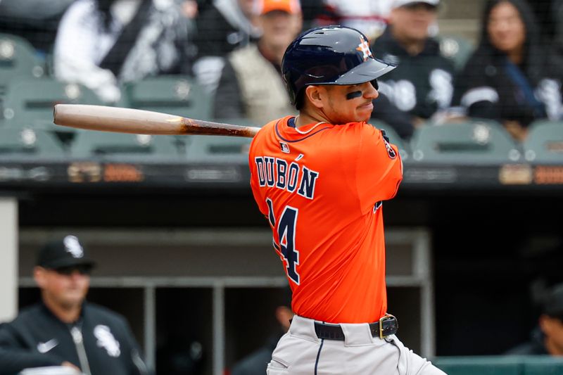 May 4, 2025; Chicago, Illinois, USA; Houston Astros third baseman Mauricio Dubón (14) hits a two-run single against the Chicago White Sox during the second inning at Rate Field. Mandatory Credit: Kamil Krzaczynski-Imagn Images