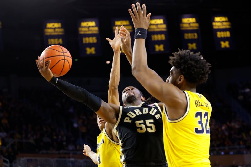 Feb 25, 2024; Ann Arbor, Michigan, USA;  Purdue Boilermakers guard Lance Jones (55) shoots on Michigan Wolverines forward Tarris Reed Jr. (32) and guard Nimari Burnett (4) in the second half at Crisler Center. Mandatory Credit: Rick Osentoski-USA TODAY Sports