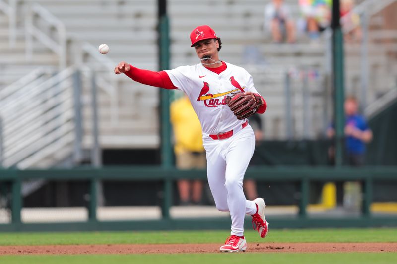 Feb 24, 2025; Jupiter, Florida, USA; St. Louis Cardinals shortstop Masyn Winn (0) throws to first base and retires New York Mets third baseman Mark Vientos (not pictured) during the third inning at Roger Dean Chevrolet Stadium. Mandatory Credit: Sam Navarro-Imagn Images