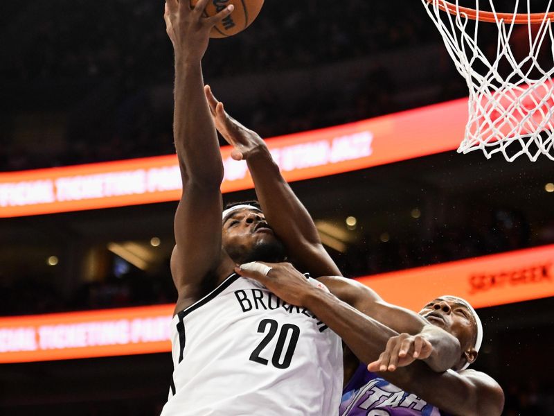 SALT LAKE CITY, UTAH - JANUARY 12: Day'Ron Sharpe #20 of the Brooklyn Nets shoots over Oscar Tshiebwe #34 of the Utah Jazz during the second half of a game at Delta Center on January 12, 2025 in Salt Lake City, Utah. NOTE TO USER: User expressly acknowledges and agrees that, by downloading and or using this photograph, User is consenting to the terms and conditions of the Getty Images License Agreement.   (Photo by Alex Goodlett/Getty Images)