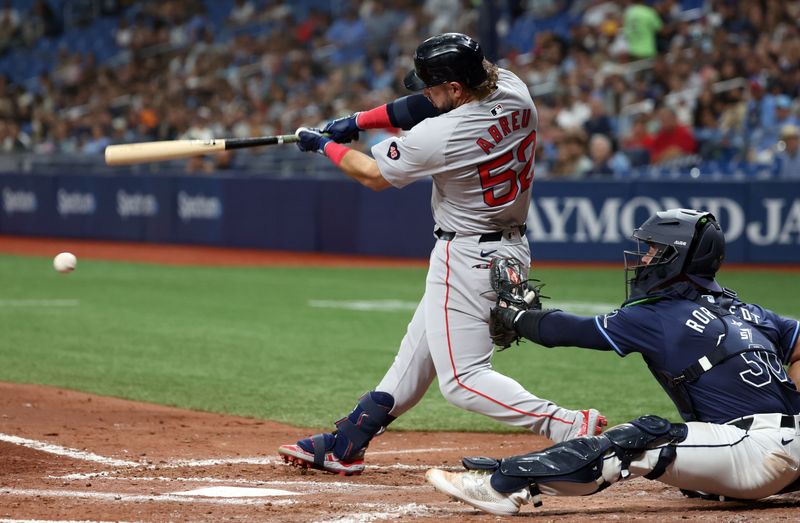 May 20, 2024; St. Petersburg, Florida, USA;  Boston Red Sox outfielder Wilyer Abreu (52) hits a RBI double during the fourth inning against the Tampa Bay Raysat Tropicana Field. Mandatory Credit: Kim Klement Neitzel-USA TODAY Sports