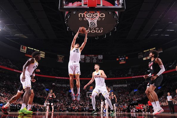 PORTLAND, OR - DECEMBER 14:  Simone Fontecchio #16 of the Utah Jazz grabs the rebound during the game  on December 14, 2023 at the Moda Center Arena in Portland, Oregon. NOTE TO USER: User expressly acknowledges and agrees that, by downloading and or using this photograph, user is consenting to the terms and conditions of the Getty Images License Agreement. Mandatory Copyright Notice: Copyright 2023 NBAE (Photo by Cameron Browne/NBAE via Getty Images)