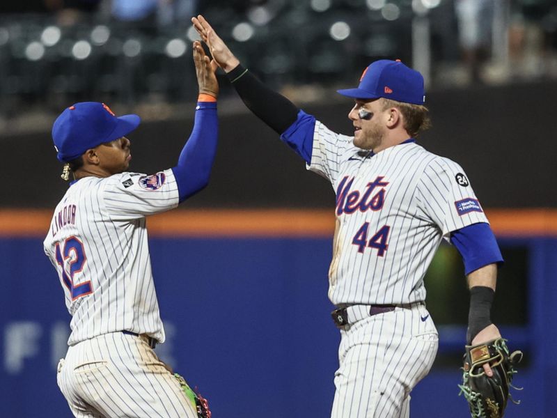 Jul 29, 2024; New York City, New York, USA;  New York Mets shortstop Francisco Lindor (12) and center fielder Harrison Bader (44) celebrate after defeating the Minnesota Twins 15-2 at Citi Field. Mandatory Credit: Wendell Cruz-USA TODAY Sports