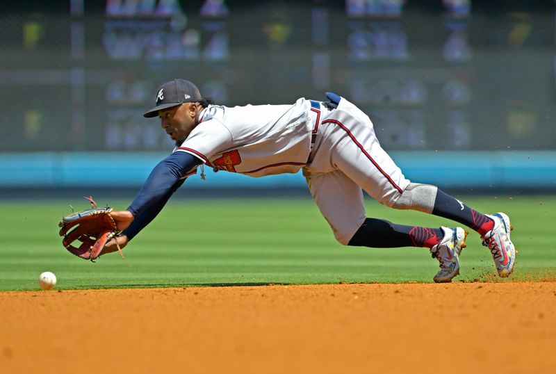 Sep 3, 2023; Los Angeles, California, USA;  Los Angeles Dodgers catcher Will Smith (16) singles past Atlanta Braves second baseman Ozzie Albies (1) in the first inning at Dodger Stadium. Mandatory Credit: Jayne Kamin-Oncea-USA TODAY Sports