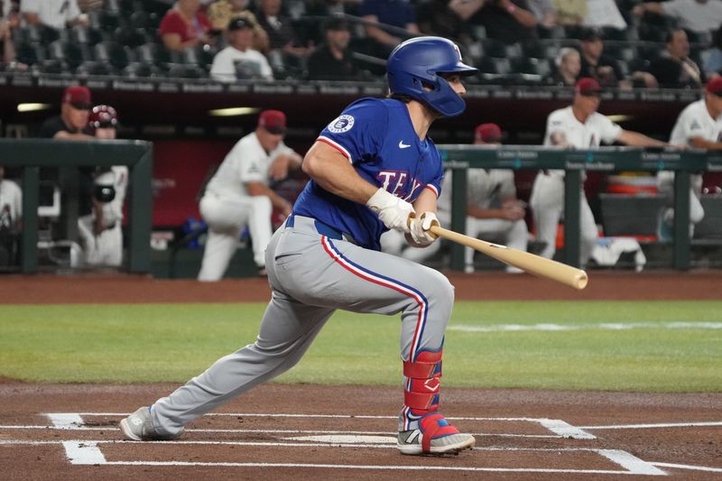 Sep 11, 2024; Phoenix, Arizona, USA; Texas Rangers outfielder Wyatt Langford (36) hits against the Arizona Diamondbacks in the first inning at Chase Field. Mandatory Credit: Rick Scuteri-Imagn Images