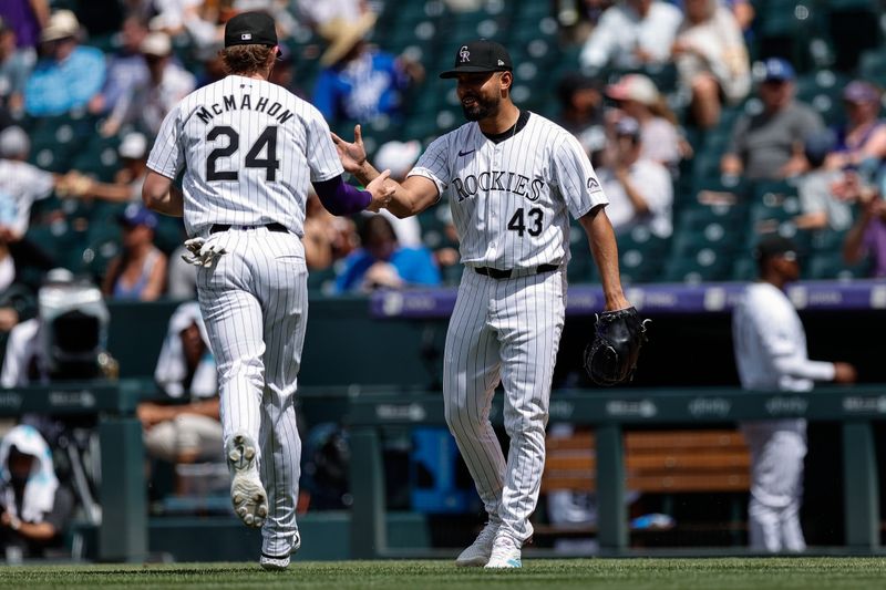 Jun 20, 2024; Denver, Colorado, USA; Colorado Rockies relief pitcher Anthony Molina (43) reacts with third baseman Ryan McMahon (24) after a play in the seventh inning against the Los Angeles Dodgers at Coors Field. Mandatory Credit: Isaiah J. Downing-USA TODAY Sports