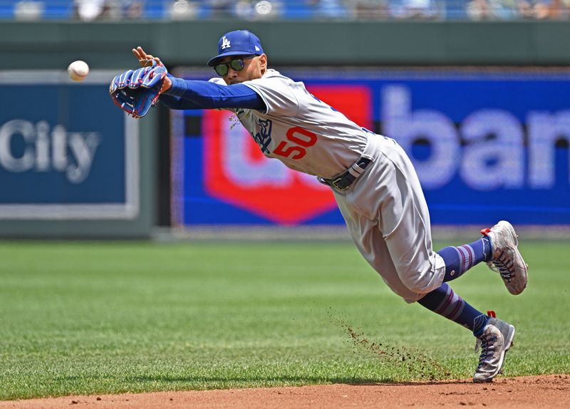 Jul 2, 2023; Kansas City, Missouri, USA;  Los Angeles Dodgers shortstop Mookie Betts (50) reaches for a hit in the first inning against the Kansas City Royals at Kauffman Stadium. Mandatory Credit: Peter Aiken-USA TODAY Sports