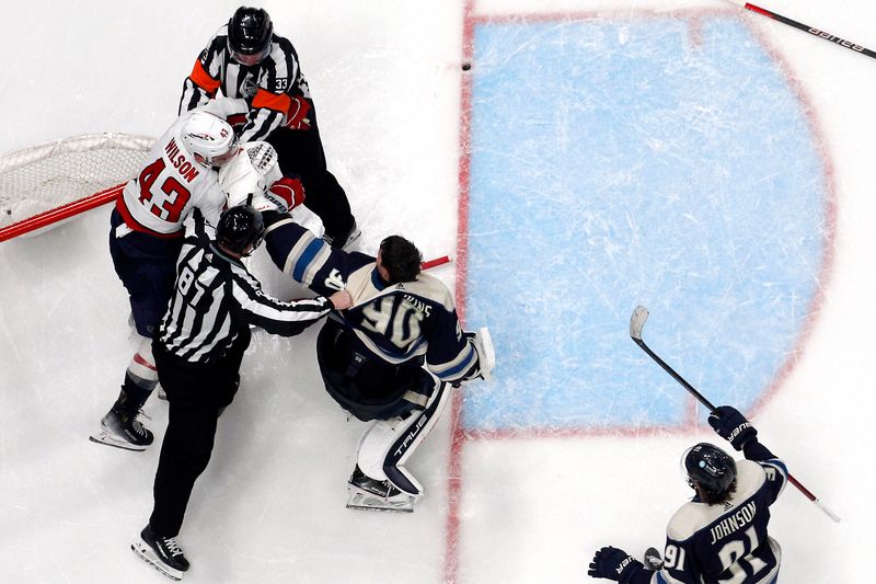 Dec 21, 2023; Columbus, Ohio, USA; A linesman separates Washington Capitals right wing Tom Wilson (43) and Columbus Blue Jackets goalie Elvis Merzlikins (90) after an altercation during overtime at Nationwide Arena. Mandatory Credit: Russell LaBounty-USA TODAY Sports