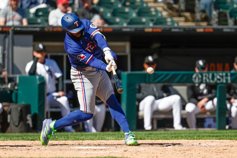 May 25, 2025; Chicago, Illinois, USA; Texas Rangers right fielder Adolis García (53) hits a two-run double against the Chicago White Sox during the ninth inning at Rate Field. Mandatory Credit: Kamil Krzaczynski-Imagn Images