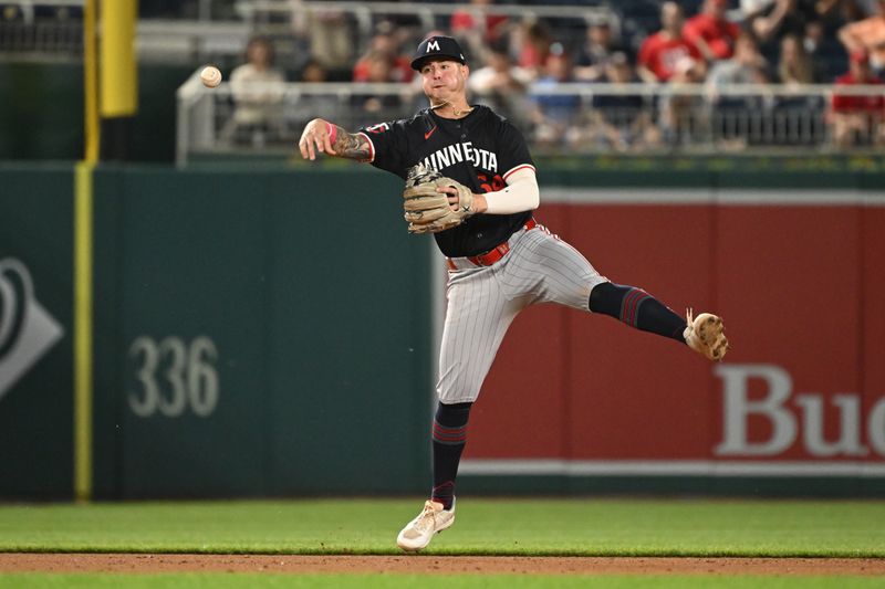 May 20, 2024; Washington, District of Columbia, USA; Minnesota Twins third base Jose Miranda (64) throws the ball to first base against the Washington Nationals during the eighth inning at Nationals Park. Mandatory Credit: Rafael Suanes-USA TODAY Sports