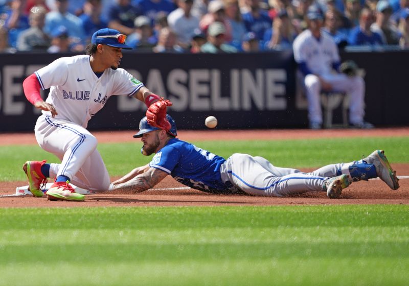 Sep 10, 2023; Toronto, Ontario, CAN; Kansas City Royals center fielder Kyle Isbel (28) slides into third base safe ahead of the tag from Toronto Blue Jays third baseman Santiago Espinal (5) during the sixth inning at Rogers Centre. Mandatory Credit: Nick Turchiaro-USA TODAY Sports