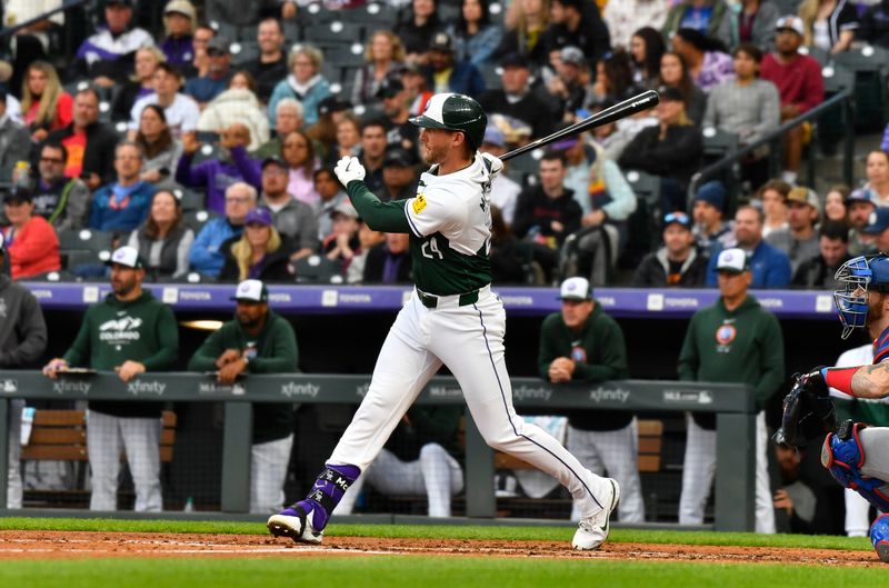 May 11, 2024; Denver, Colorado, USA; Colorado Rockies third base Ryan McMahon (24) hits a single against the Texas Rangers in the third inning at Coors Field. Mandatory Credit: John Leyba-USA TODAY Sports