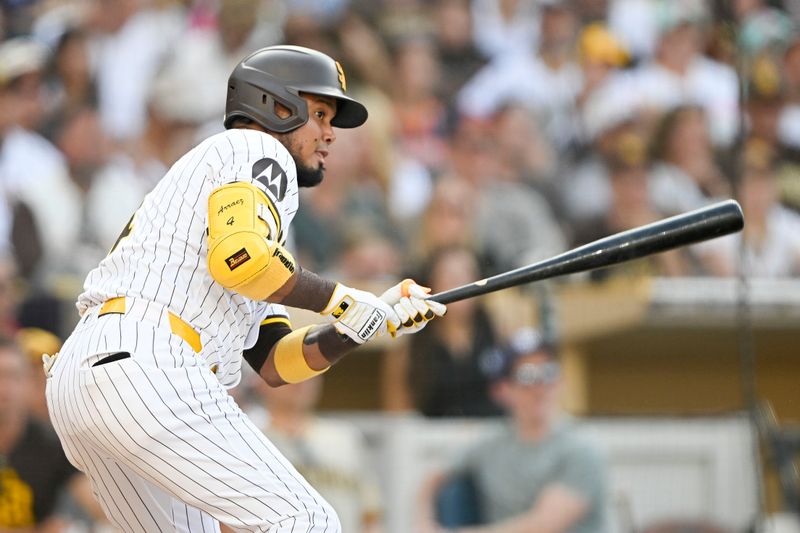 Sep 2, 2024; San Diego, California, USA; San Diego Padres first baseman Luis Arraez (4) hits a RBI single during the the third inning against the Detroit Tigers at Petco Park. Mandatory Credit: Denis Poroy-USA TODAY Sports