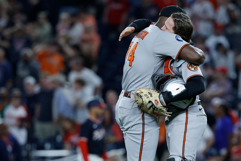 Apr 24, 2025; Washington, District of Columbia, USA; Baltimore Orioles pitcher Félix Bautista (74) celebrates with Orioles catcher Adley Rutschman (35) after their game against the Washington Nationals at Nationals Park. Mandatory Credit: Geoff Burke-Imagn Images