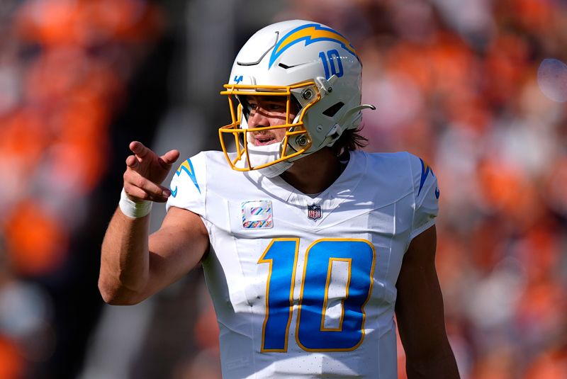 Los Angeles Chargers quarterback Justin Herbert (10) reacts after a Chargers first down during the first half of an NFL football game against the Denver Broncos, Sunday, Oct. 13, 2024, in Denver. (AP Photo/David Zalubowski)