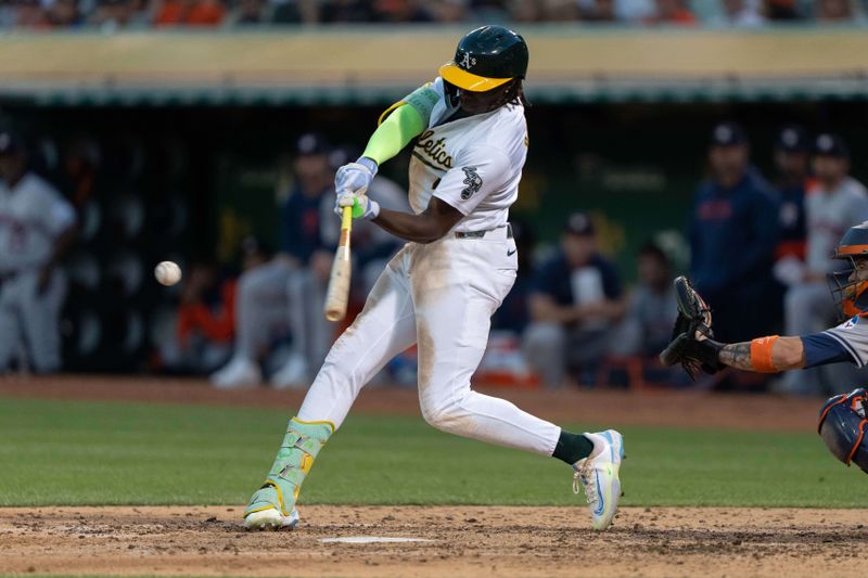 Jul 23, 2024; Oakland, California, USA;  Oakland Athletics outfielder Lawrence Butler (4) hits an RBI double during the sixth inning against the Houston Astros at Oakland-Alameda County Coliseum. Mandatory Credit: Stan Szeto-USA TODAY Sports