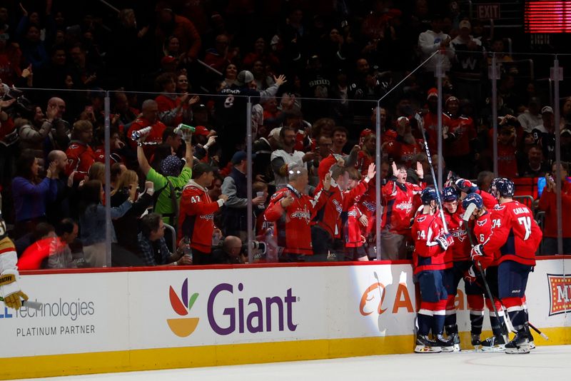 Oct 15, 2024; Washington, District of Columbia, USA; Washington Capitals defenseman Jakob Chychrun (6) celebrates with teammates after scoring a goal against the Vegas Golden Knights in the second period at Capital One Arena. Mandatory Credit: Geoff Burke-Imagn Images