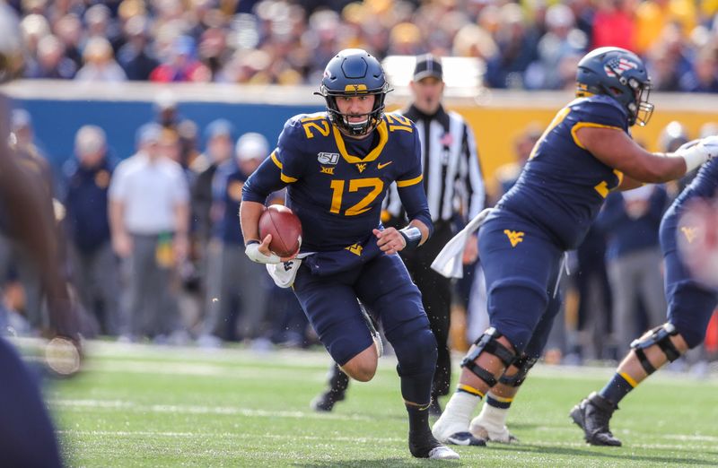 Nov 9, 2019; Morgantown, WV, USA; West Virginia Mountaineers quarterback Austin Kendall (12) runs the ball during the first quarter against the Texas Tech Red Raiders at Mountaineer Field at Milan Puskar Stadium. Mandatory Credit: Ben Queen-USA TODAY Sports