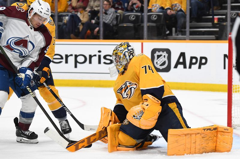 Mar 2, 2024; Nashville, Tennessee, USA; Nashville Predators goaltender Juuse Saros (74) makes a save on a play by Colorado Avalanche left wing Zach Parise (9) during the second period at Bridgestone Arena. Mandatory Credit: Christopher Hanewinckel-USA TODAY Sports