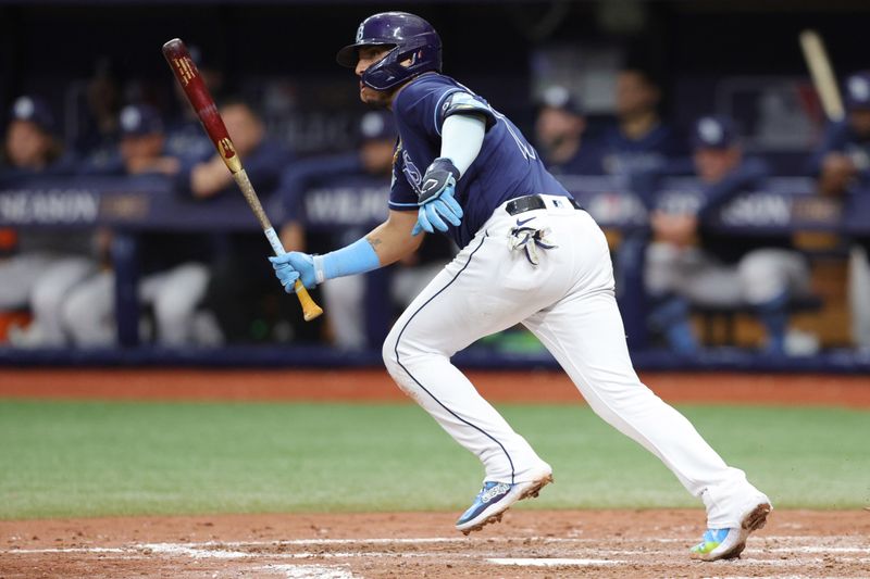 Oct 4, 2023; St. Petersburg, Florida, USA; Tampa Bay Rays third baseman Isaac Paredes (17) hits a single against the Texas Rangers in the seventh inning during game two of the Wildcard series for the 2023 MLB playoffs at Tropicana Field. Mandatory Credit: Nathan Ray Seebeck-USA TODAY Sports