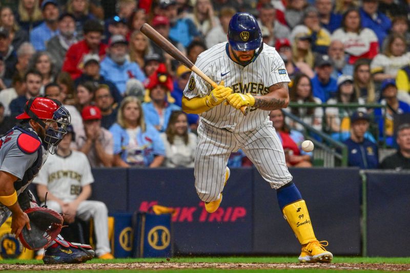 May 11, 2024; Milwaukee, Wisconsin, USA; Milwaukee Brewers designated hitter Gary Sanchez (99) is hit by a pitch with the bases loaded to force in a run against the St. Louis Cardinals in the sixth inning at American Family Field. Mandatory Credit: Benny Sieu-USA TODAY Sports