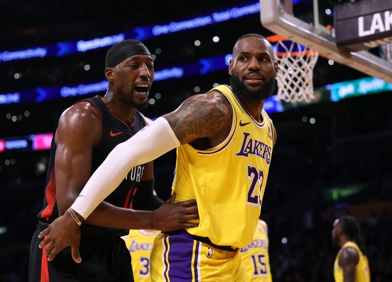 LOS ANGELES, CALIFORNIA - JANUARY 03: LeBron James #23 of the Los Angeles Lakers shields Bam Adebayo #13 of the Miami Heat from a rebound during the first half at Crypto.com Arena on January 03, 2024 in Los Angeles, California. (Photo by Harry How/Getty Images)