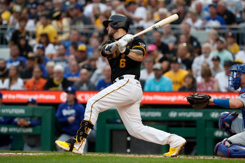 Jun 5, 2024; Pittsburgh, Pennsylvania, USA;  Pittsburgh Pirates catcher Yasmani Grandal (6) hits an RBI single against the Los Angeles Dodgers during the second inning at PNC Park. Mandatory Credit: Charles LeClaire-USA TODAY Sports