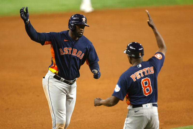 Sep 5, 2023; Arlington, Texas, USA; Houston Astros designated hitter Yordan Alvarez (44) celebrates a two run home run with third base coach Gary Pettis (8) in the seventh inning against the Texas Rangers at Globe Life Field. Mandatory Credit: Tim Heitman-USA TODAY Sports