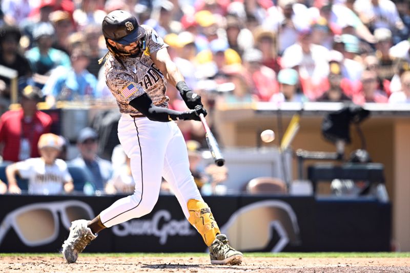 Apr 28, 2024; San Diego, California, USA; San Diego Padres right fielder Fernando Tatis Jr. (23) hits an RBI double against the Philadelphia Phillies during the third inning at Petco Park. Mandatory Credit: Orlando Ramirez-USA TODAY Sports