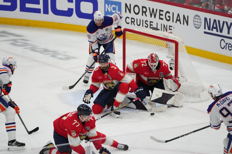 Jun 9, 2025; Sunrise, Florida, USA; Florida Panthers goaltender Sergei Bobrovsky (72) and defenseman Seth Jones (3) defend against Edmonton Oilers center Connor McDavid (97) during the first period in game three of the 2025 Stanley Cup Final at Amerant Bank Arena. Mandatory Credit: Jim Rassol-Imagn Images