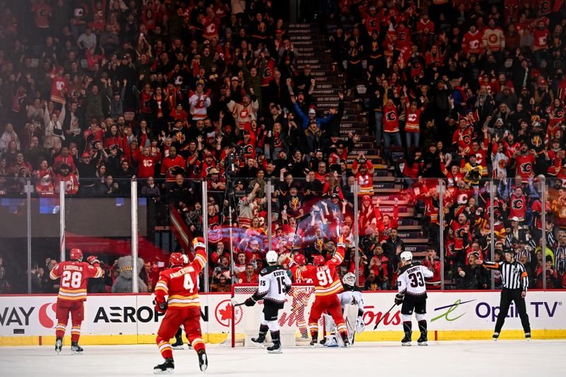 Jan 16, 2024; Calgary, Alberta, CAN; Calgary Flames center Yegor Sharangovich (17), teammates and fans celebrate after scoring in overtime against the Arizona Coyotes at Scotiabank Saddledome. Mandatory Credit: Brett Holmes-USA TODAY Sports