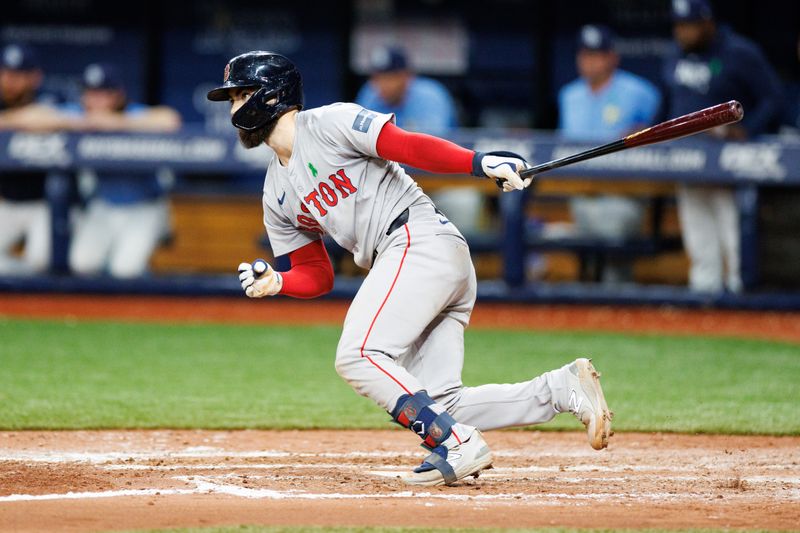 May 22, 2024; St. Petersburg, Florida, USA;  Boston Red Sox catcher Connor Wong (12) hits a two rbi single against the Tampa Bay Rays in the fifth inning at Tropicana Field. Mandatory Credit: Nathan Ray Seebeck-USA TODAY Sports