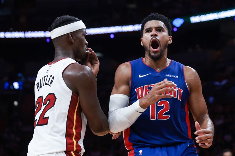 MIAMI, FLORIDA - OCTOBER 28: Tobias Harris #12 of the Detroit Pistons reacts ahead of Jimmy Butler #22 of the Miami Heat during the first half at Kaseya Center on October 28, 2024 in Miami, Florida. NOTE TO USER: User expressly acknowledges and agrees that, by downloading and or using this photograph, User is consenting to the terms and conditions of the Getty Images License Agreement. (Photo by Carmen Mandato/Getty Images)
