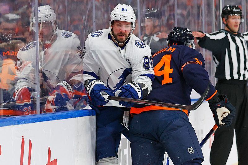 Dec 14, 2023; Edmonton, Alberta, CAN; Edmonton Oilers defensemen Mattias Ekholm (14) checks Tampa Bay Lightning forward Nikita Kucherov (86) during the second period at Rogers Place. Mandatory Credit: Perry Nelson-USA TODAY Sports