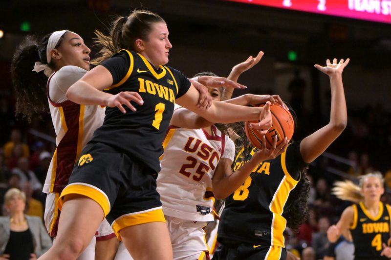 Jan 29, 2026; Los Angeles, California, USA;  USC Trojans guard Kennedy Smith (11), guard Kara Dunn (25), Iowa Hawkeyes guard Taylor Stremlow (1) and guard Journey Houston (8) fight for a rebound in the second half at Galen Center. Mandatory Credit: Jayne Kamin-Oncea-Imagn Images
