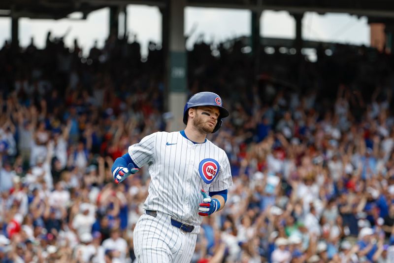 Jul 4, 2024; Chicago, Illinois, USA; Chicago Cubs outfielder Ian Happ (8) rounds the bases after hitting a three-run home run against the Philadelphia Phillies during the fourth inning at Wrigley Field. Mandatory Credit: Kamil Krzaczynski-USA TODAY Sports